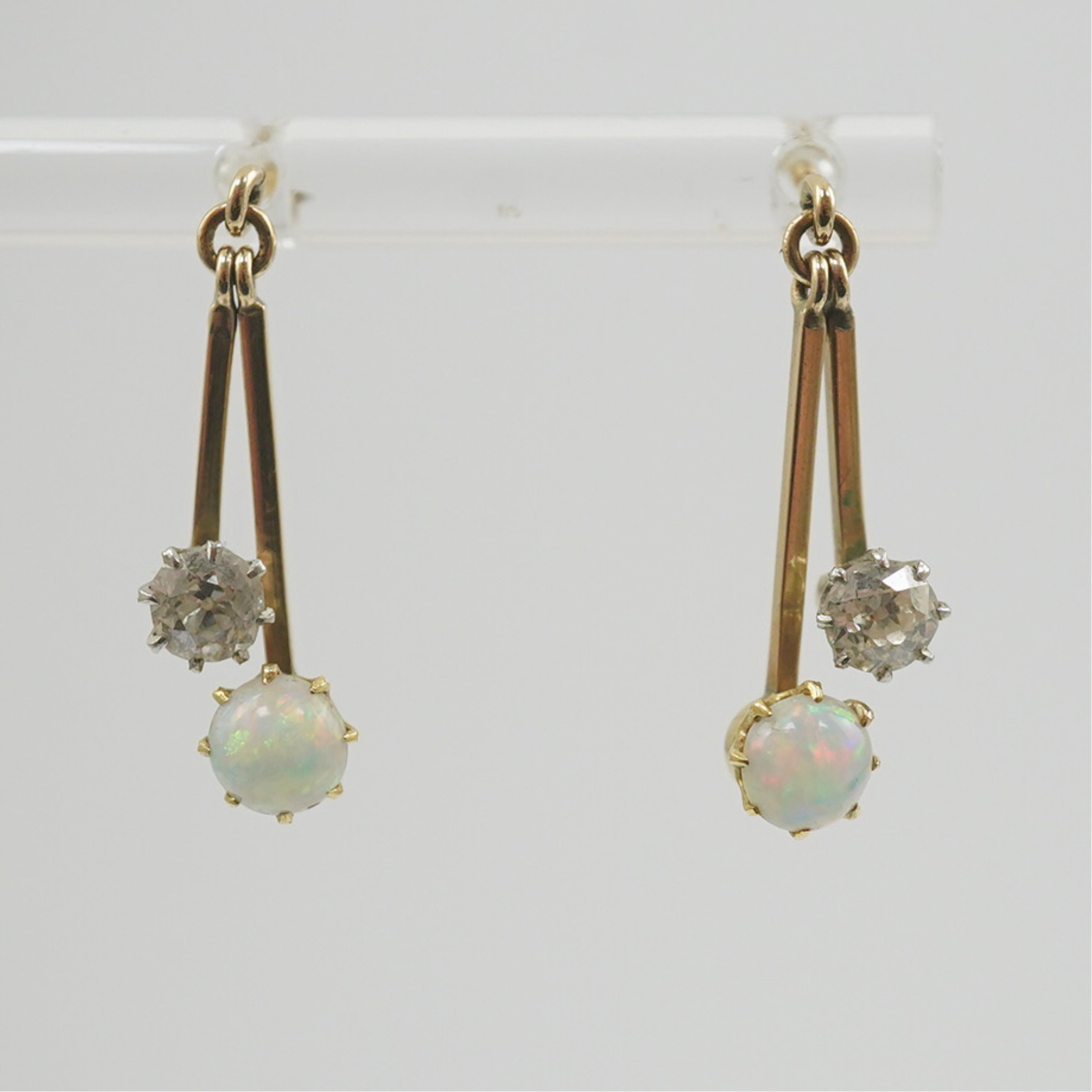 A pair of 9ct gold, white opal and diamond set double drop earrings